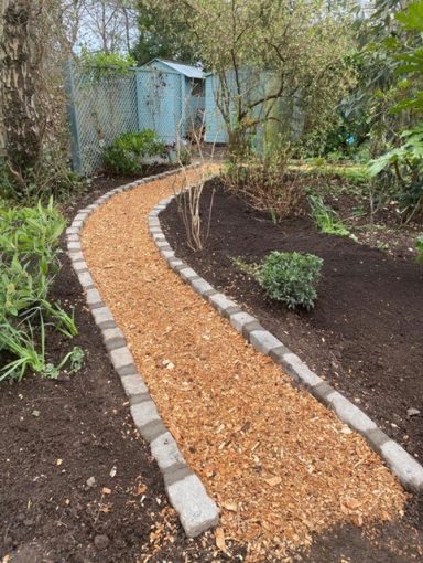 garden clearance and wood chipping path with stone cobble